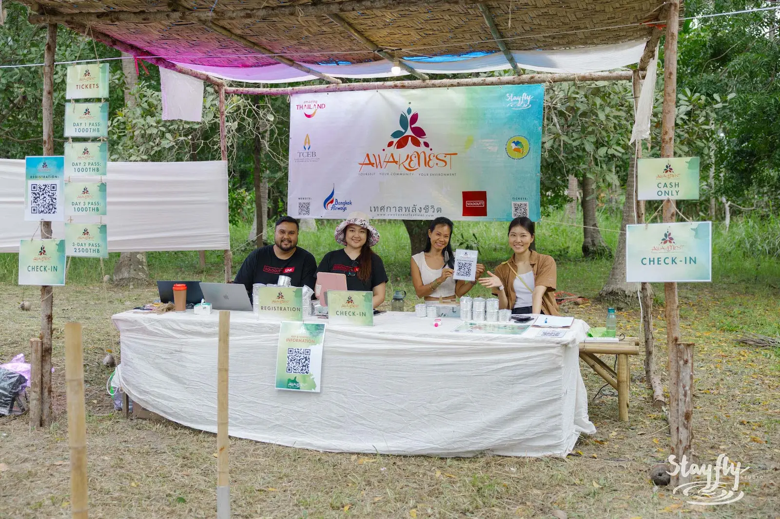 Staff at Awakenest check-in registration table.