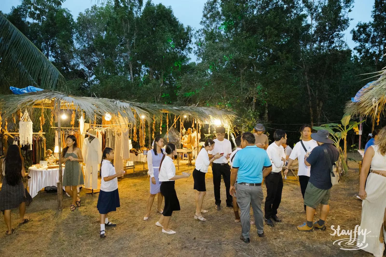 People gathered at evening market stalls.