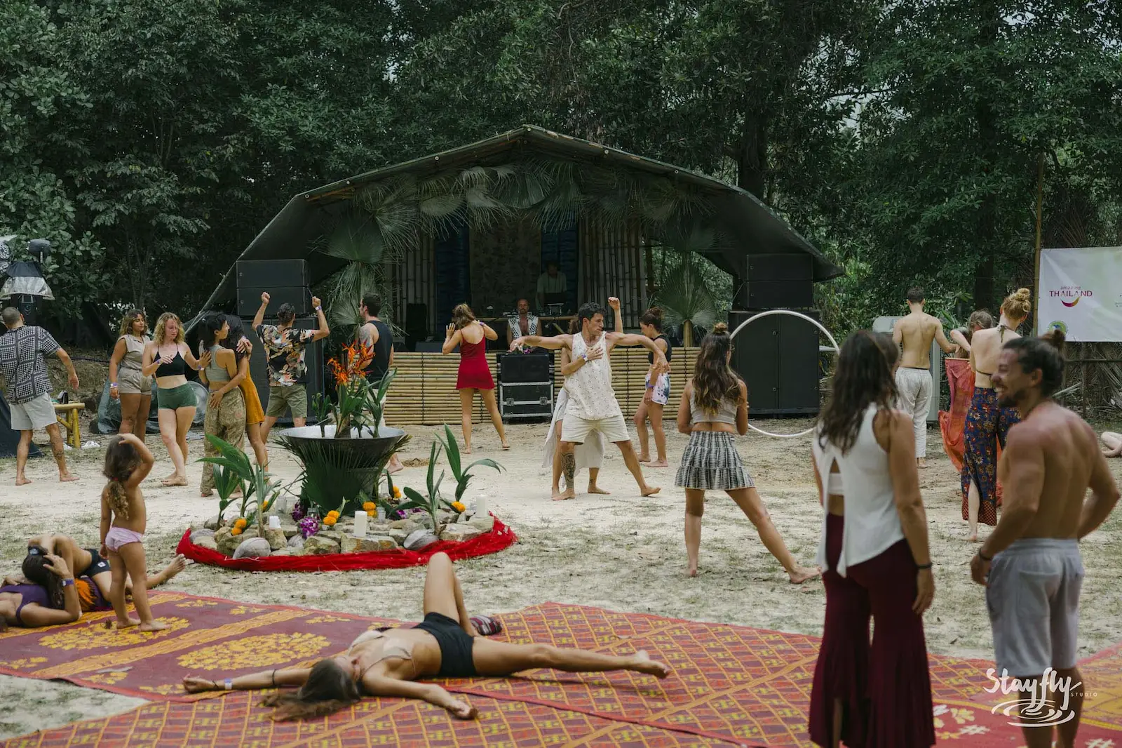 Daytime dance circle with hula hoop near stage.