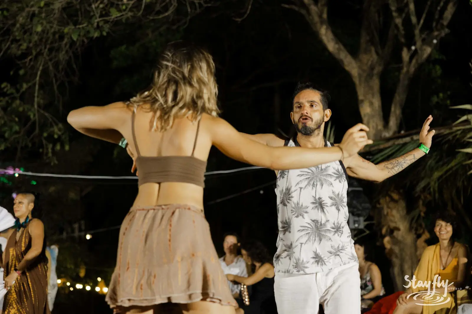 Couple dancing together at night.