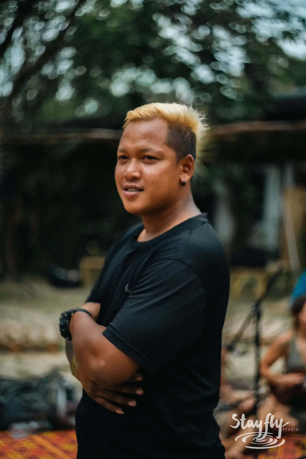 Portrait of man with blond dyed hair outdoors.