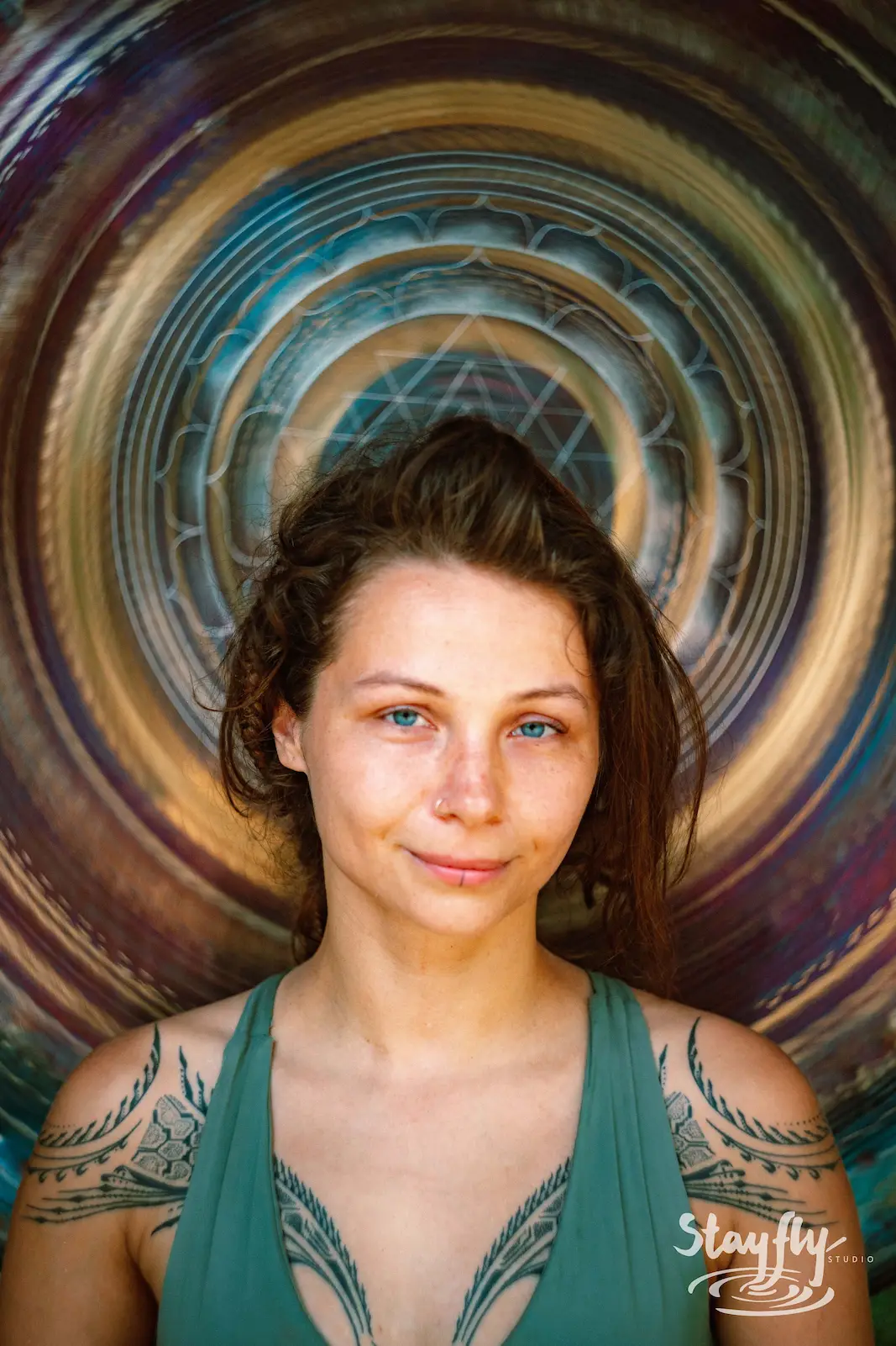 Portrait of woman with mandala background overlay.