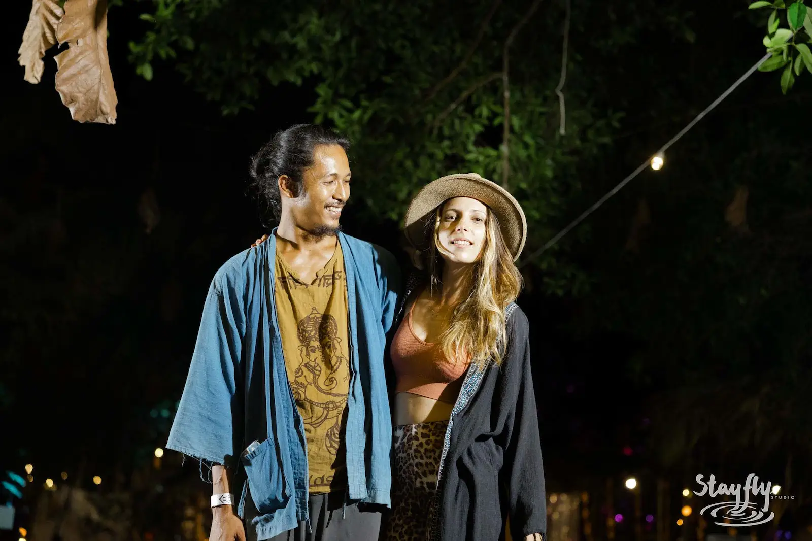 Couple smiling together at night market.