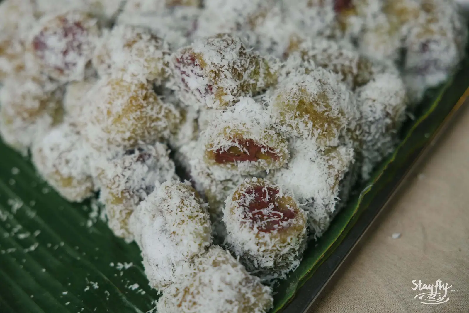 Coconut-coated sweets on banana leaf.
