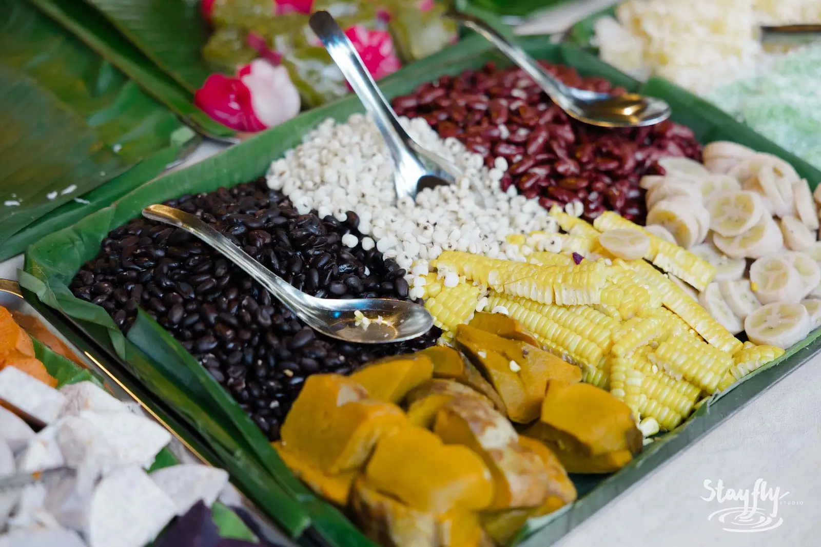 Buffet spread of beans corn and banana.