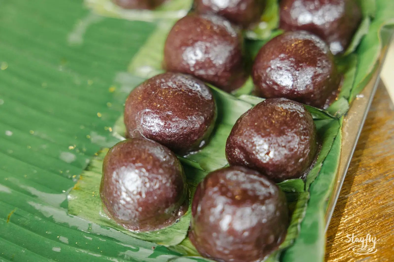 Dark sweet dumplings on banana leaf.