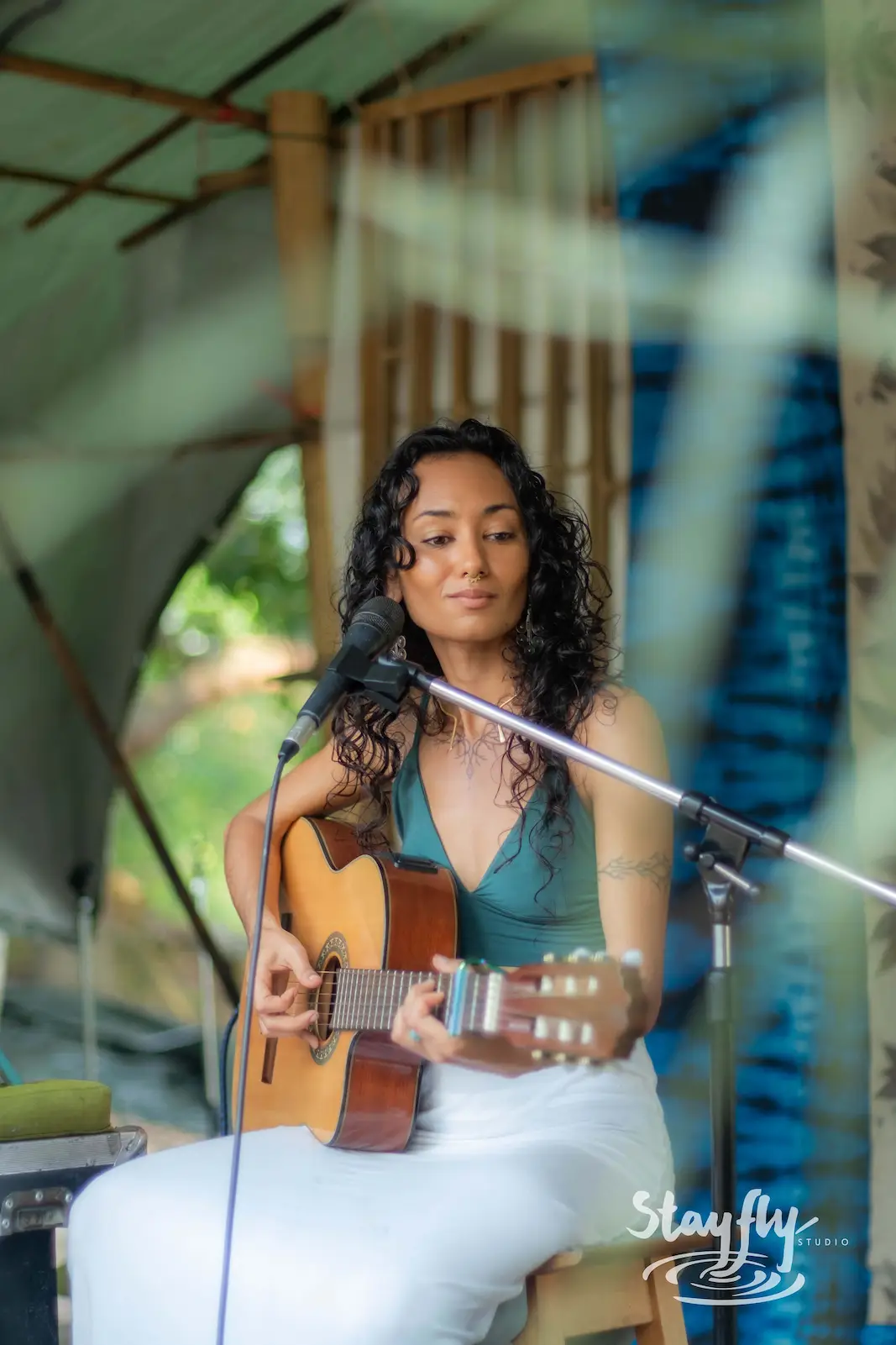 Woman playing acoustic guitar and singing.