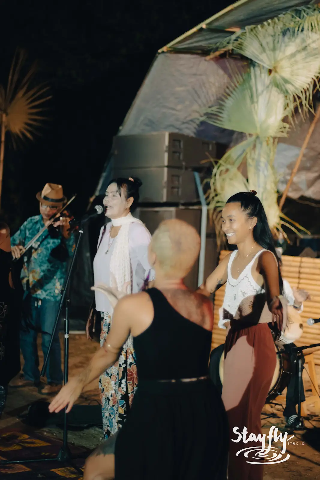 Singers and dancer performing together on stage.
