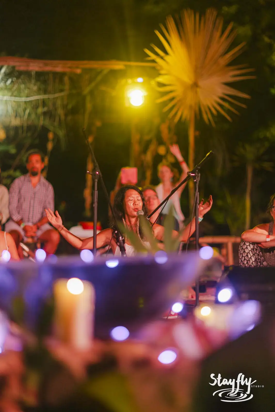 Night music circle with candles in foreground.