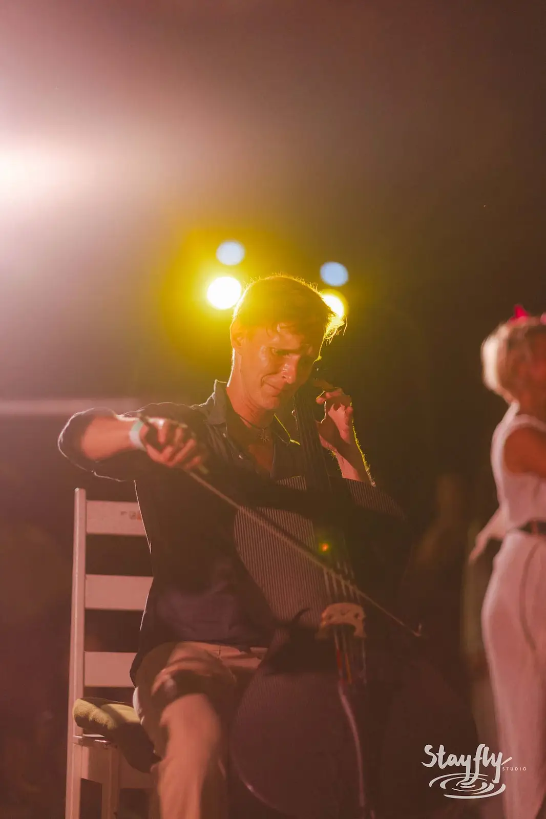 Man playing guitar and singing at night.