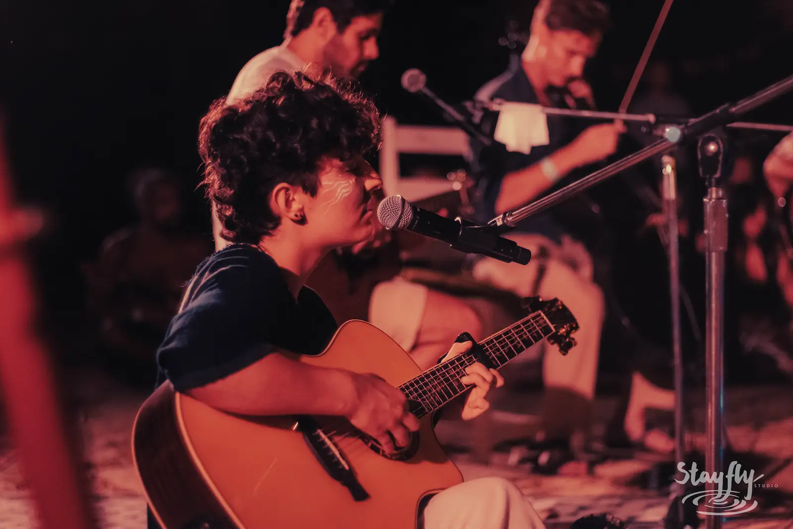 Small acoustic group performing together outdoors.