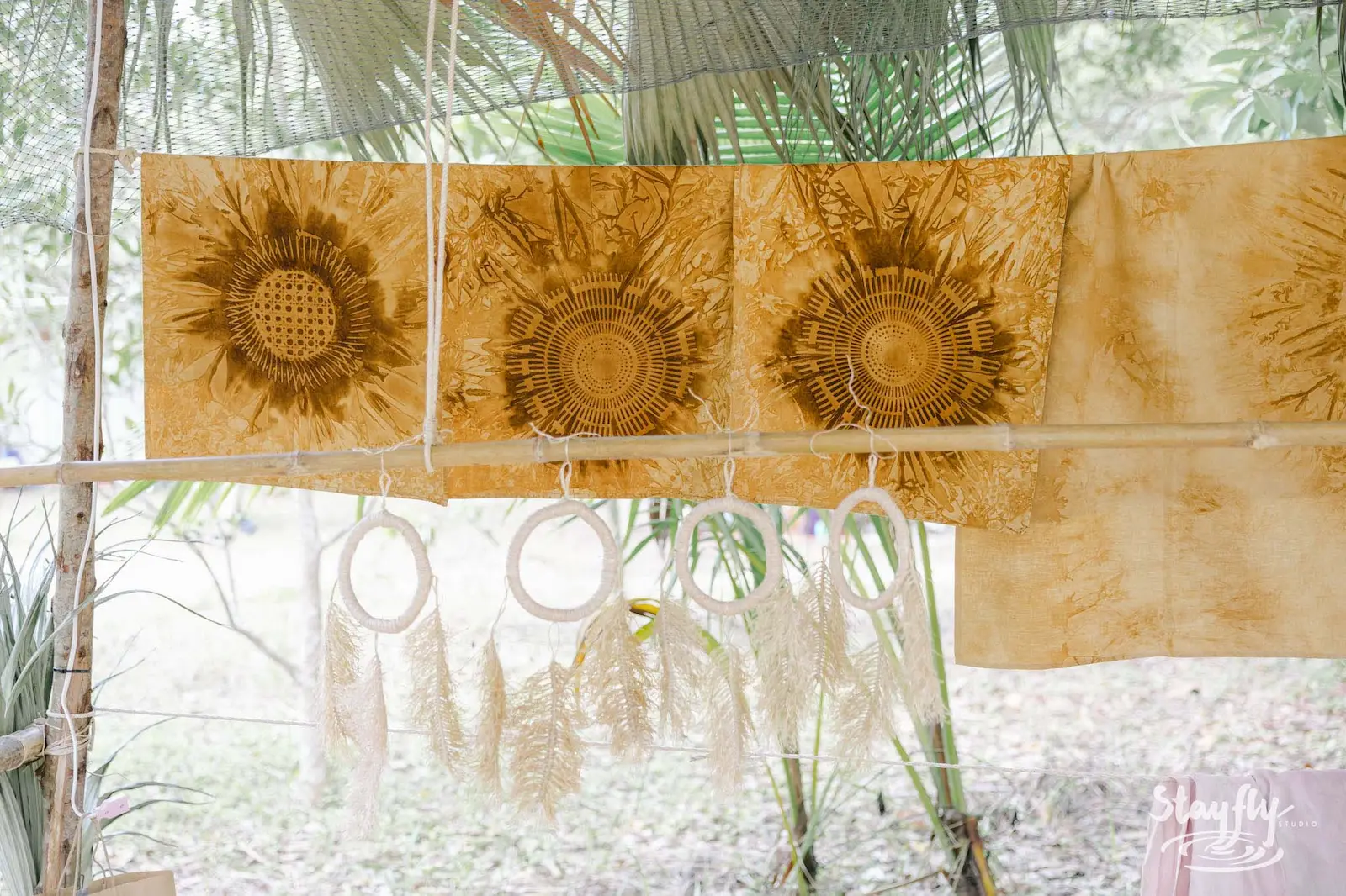 Printed sunflower fabric panels hanging with dreamcatchers.