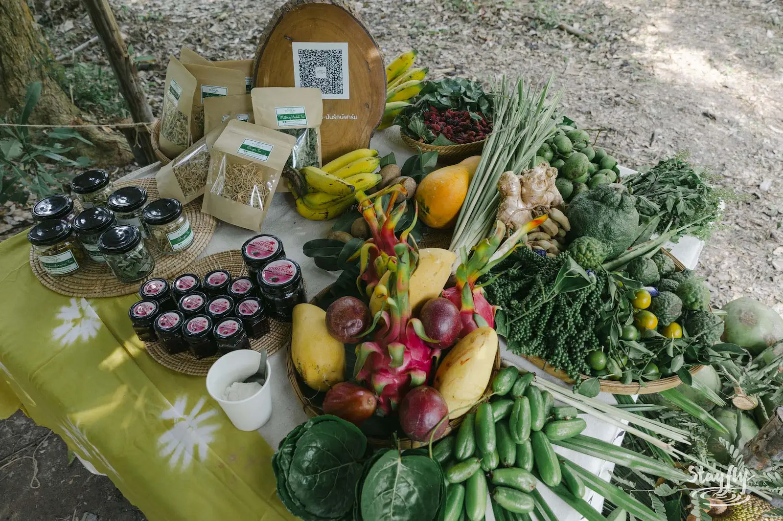Market table with preserves, dragonfruit and greens.