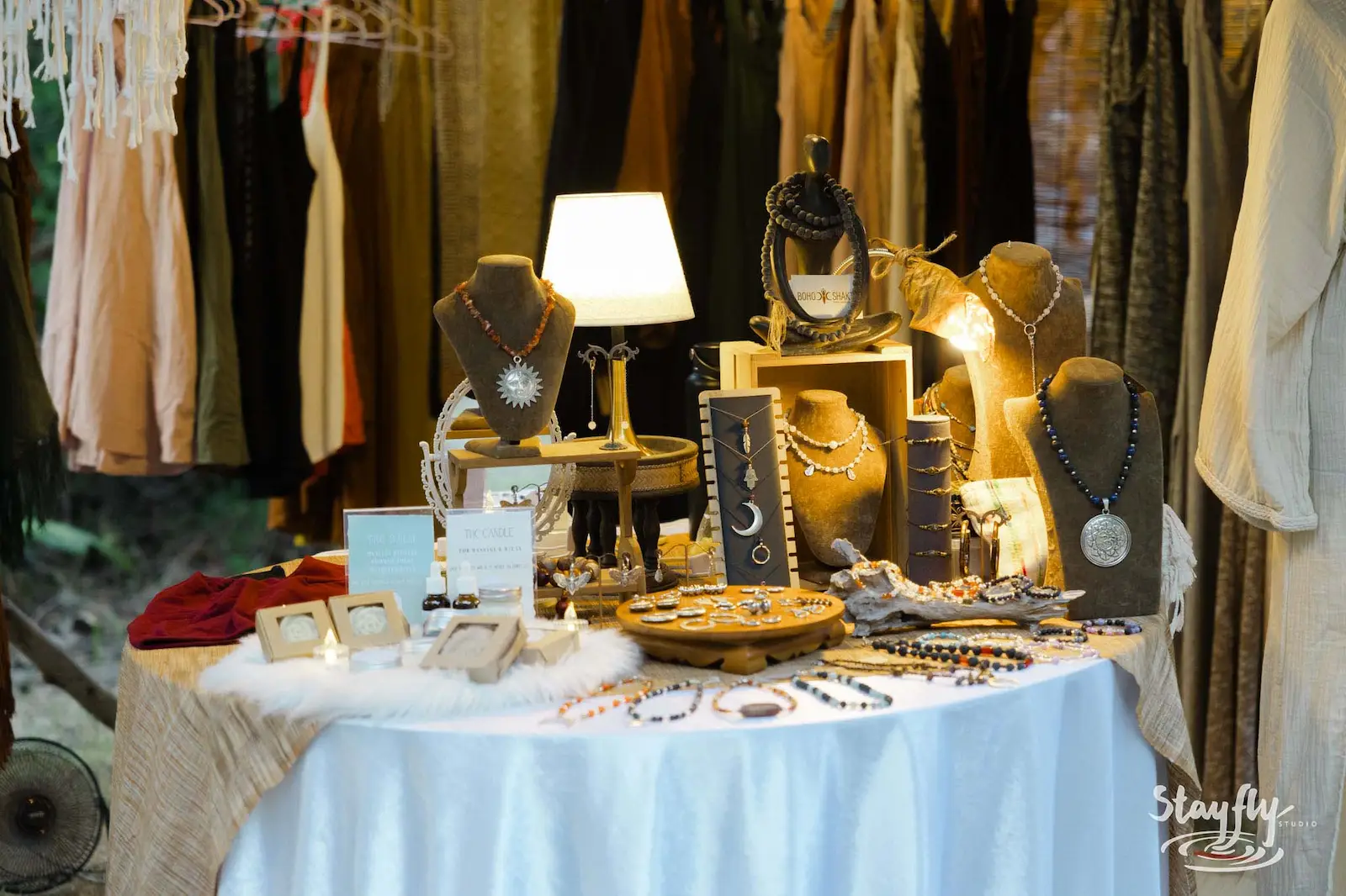 Jewelry displayed on stands at market table.