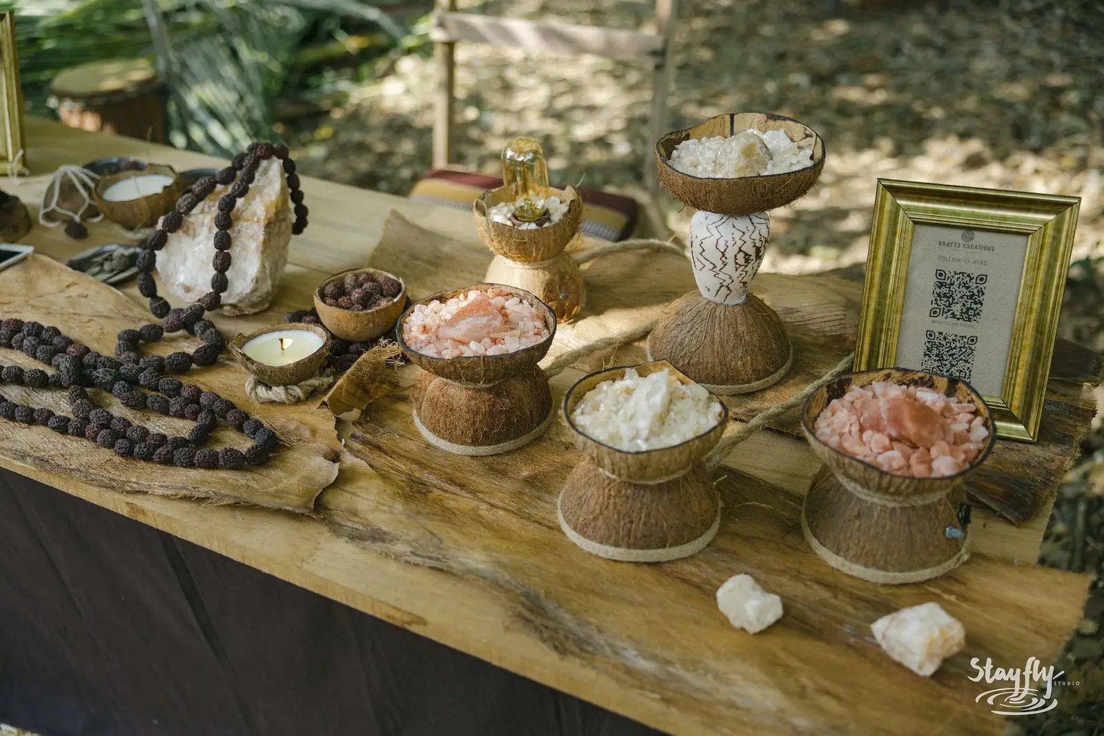 Crystals and salt bowls in coconut shells on market table.