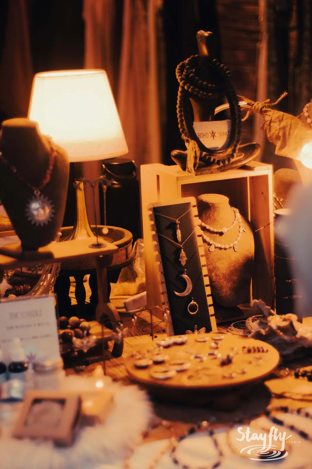 Jewelry and beads displayed on market stall table.