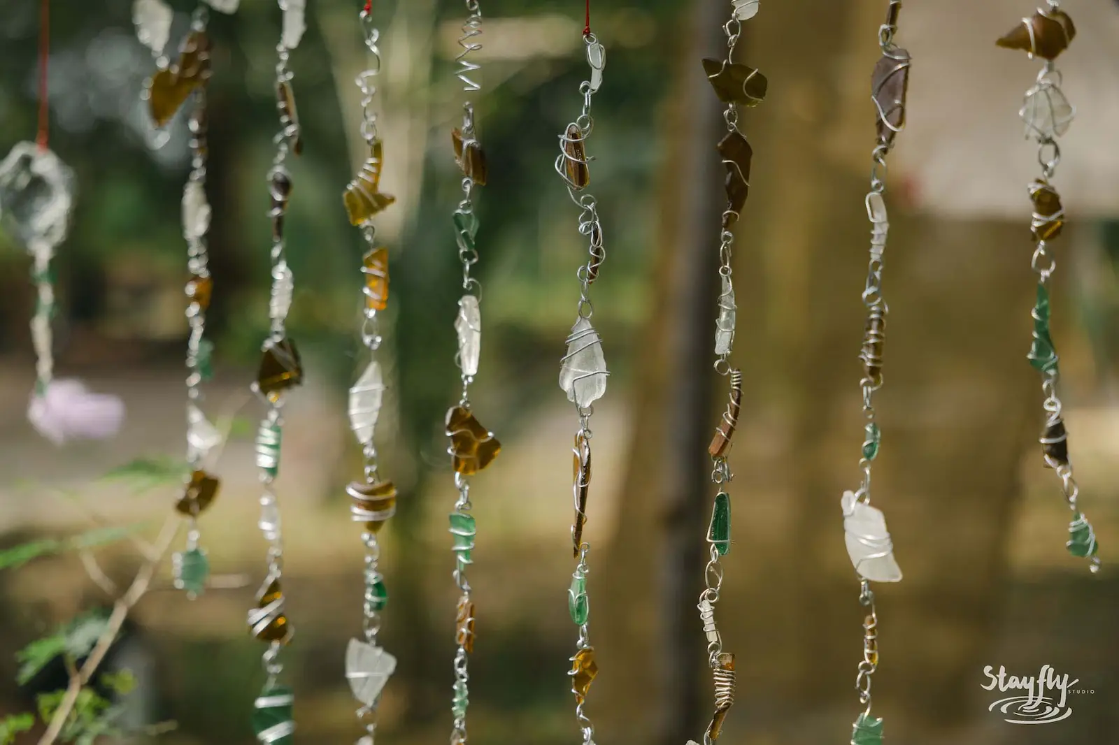 Hanging beaded glass strands as market decor.