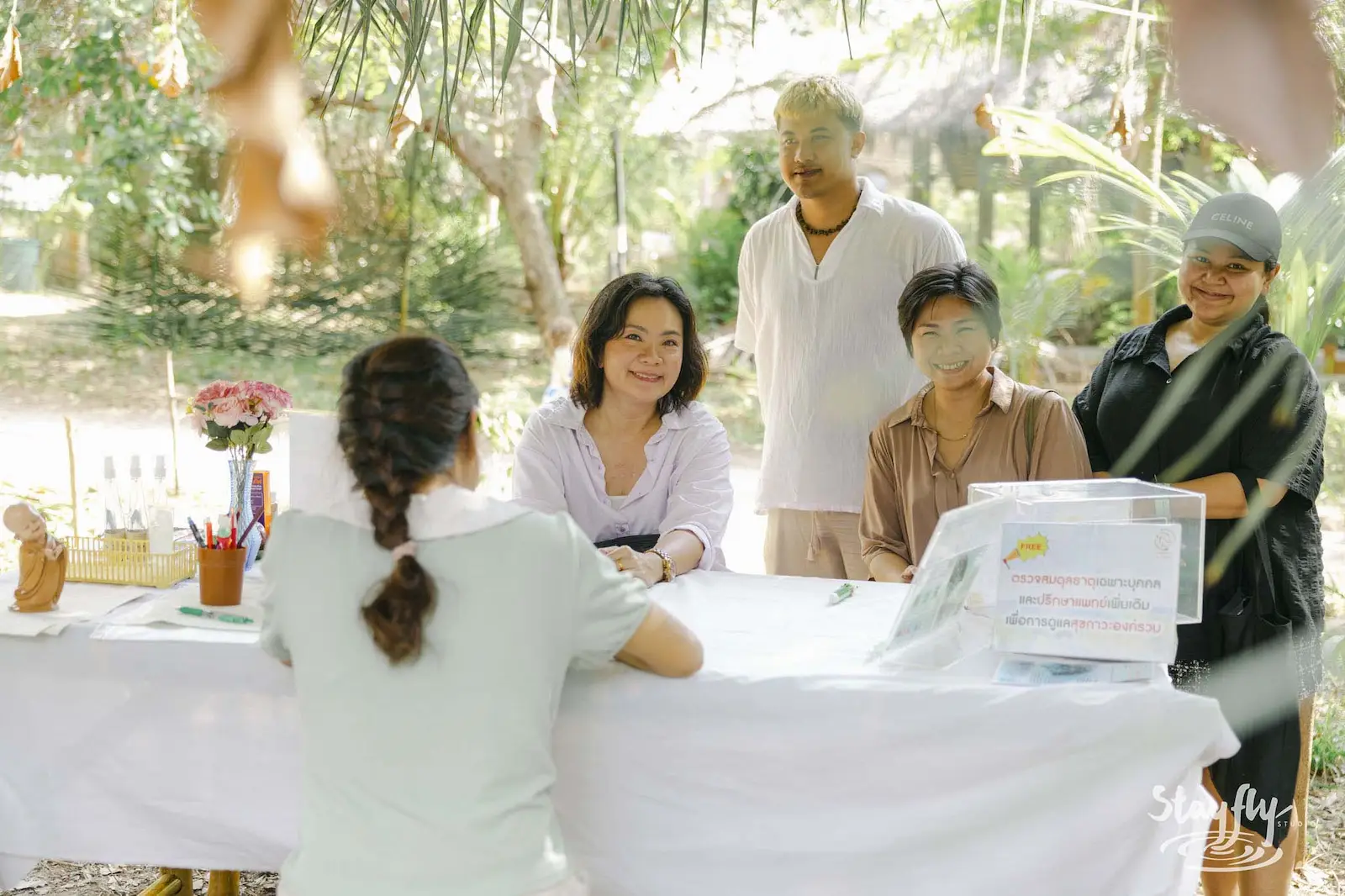 Group gathered at an outdoor market table.