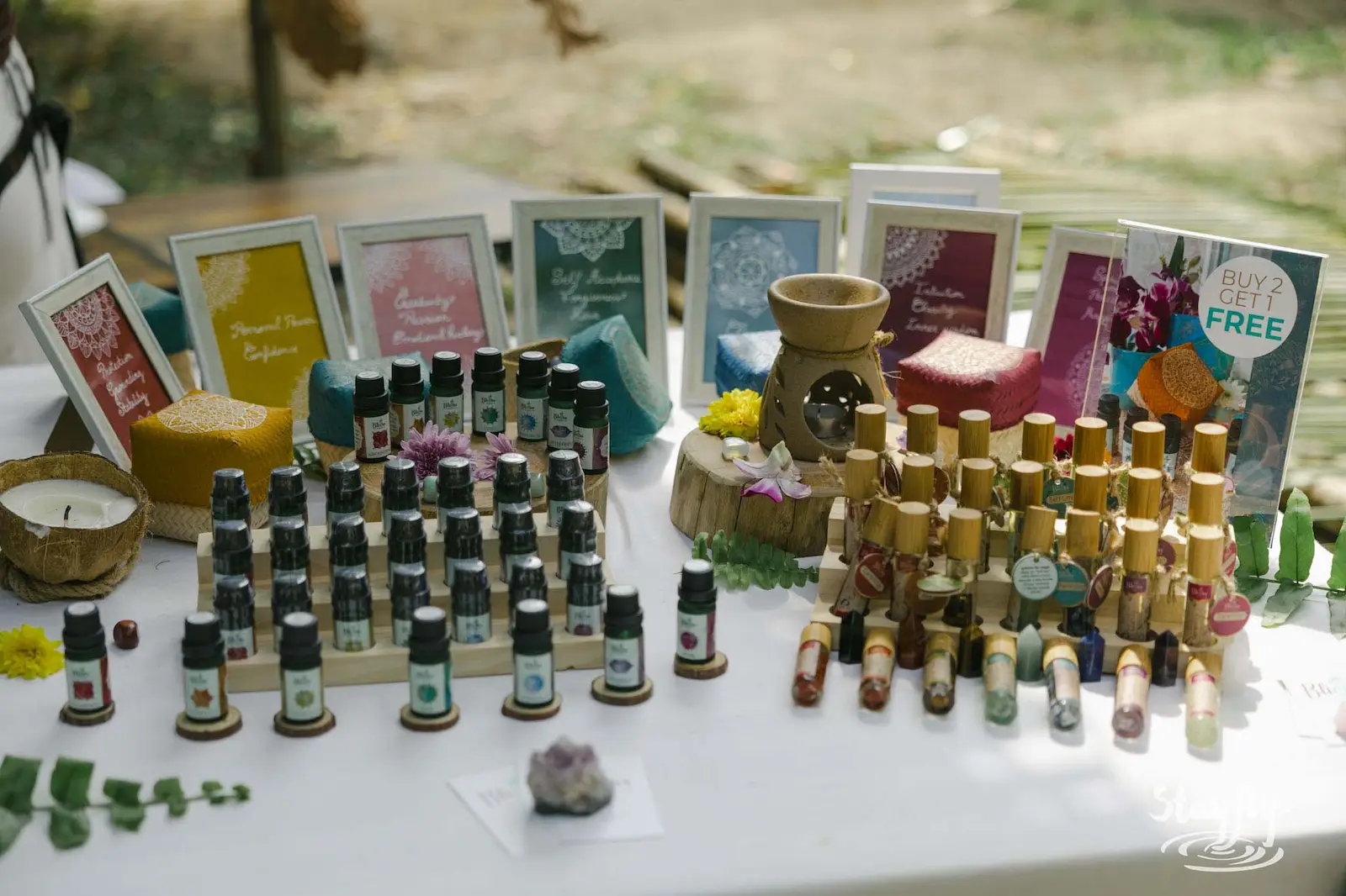 Essential oil bottles displayed at a stall.