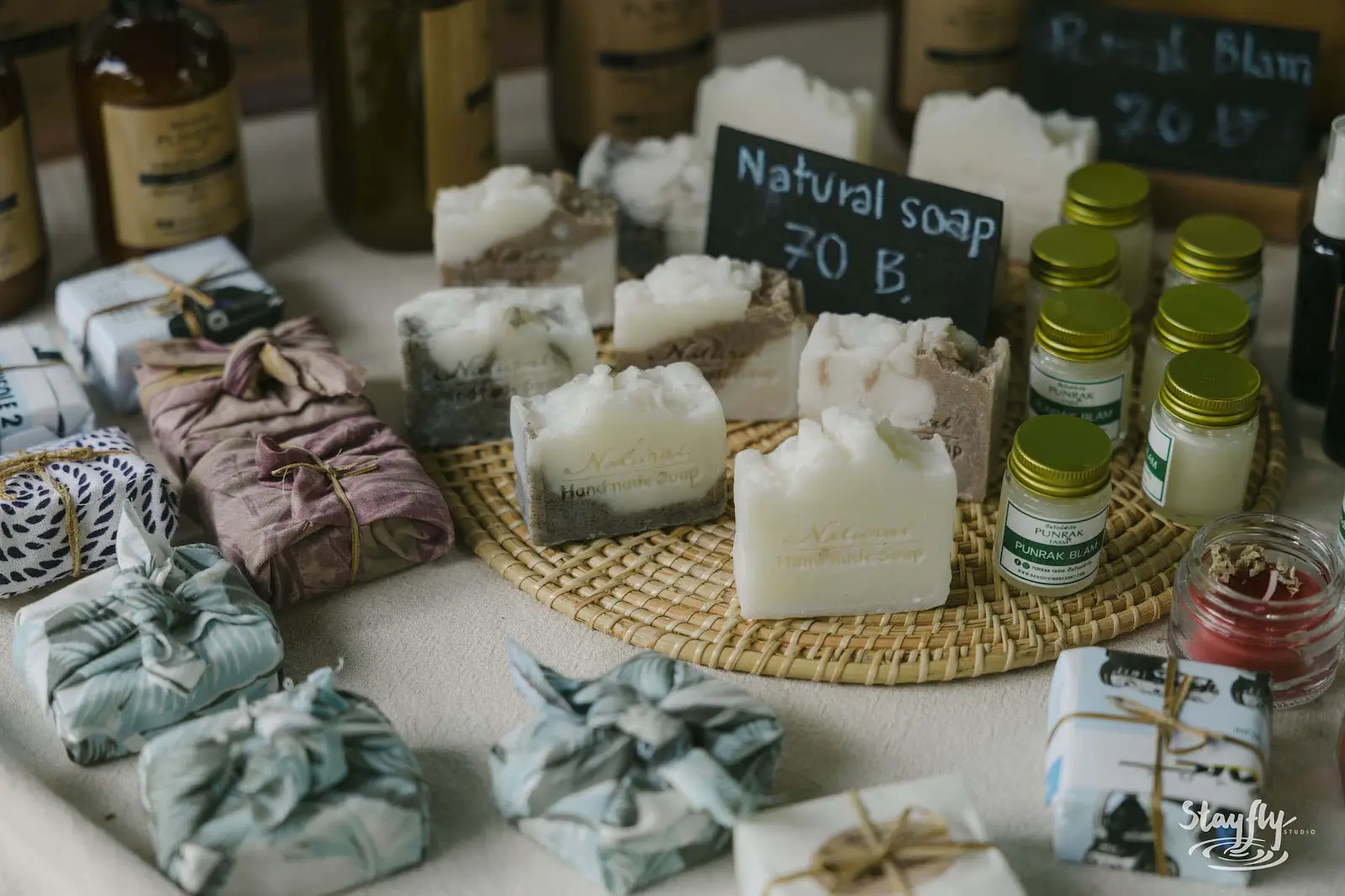 Wrapped natural soaps displayed at a stall.