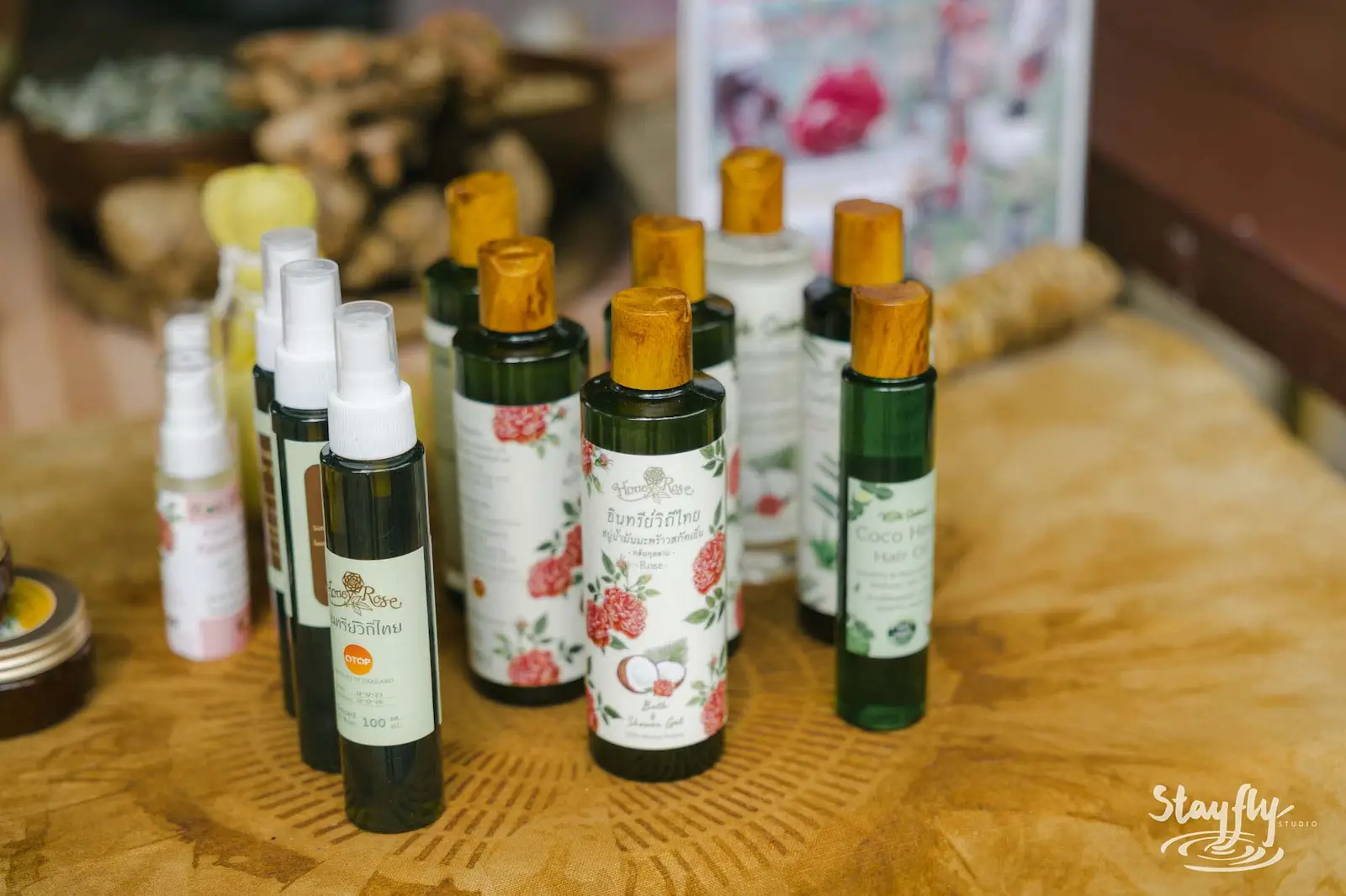 Herbal oil bottles displayed on market table.