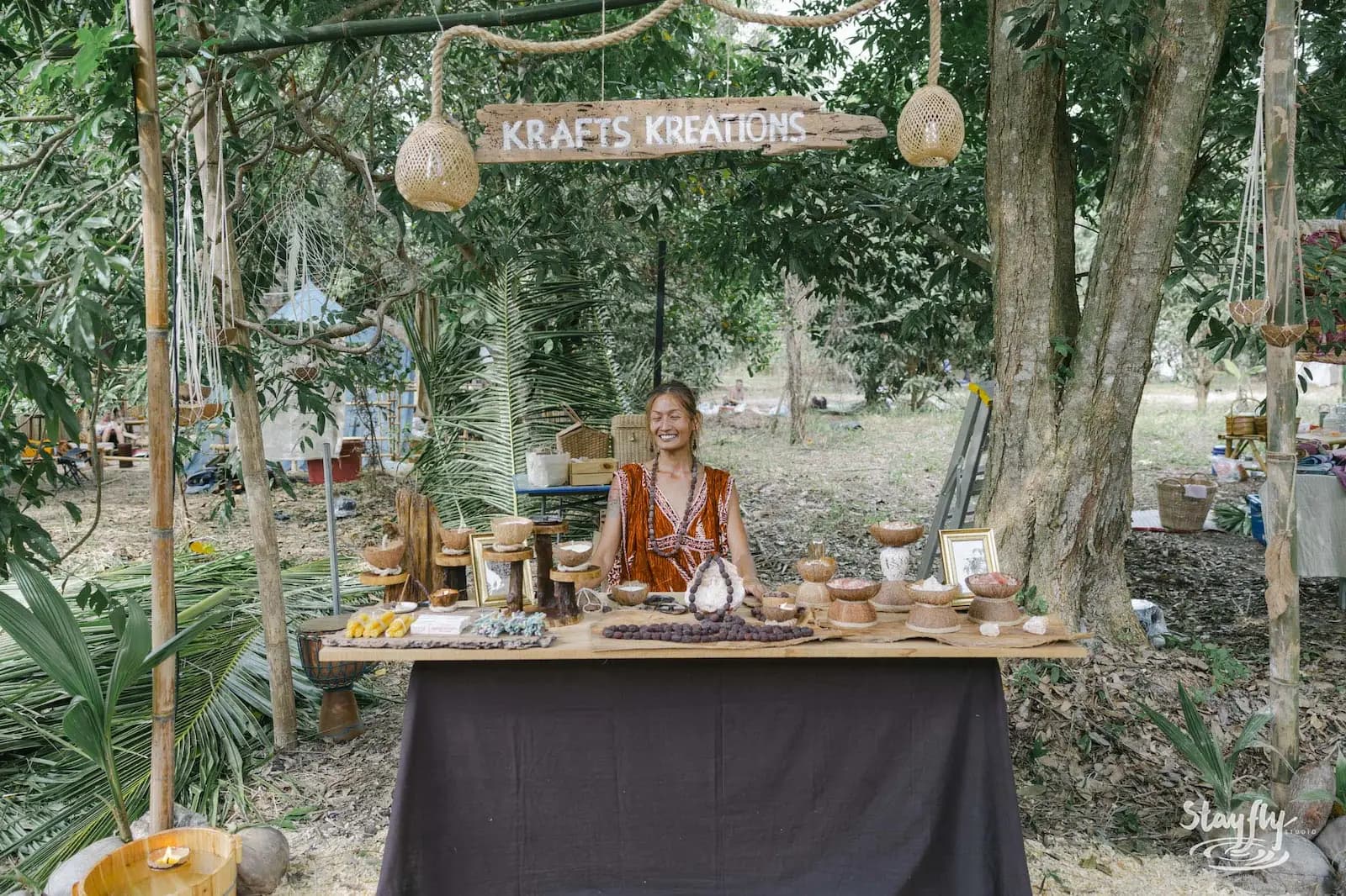 Vendor at Krafts Kreations stall with handmade goods.