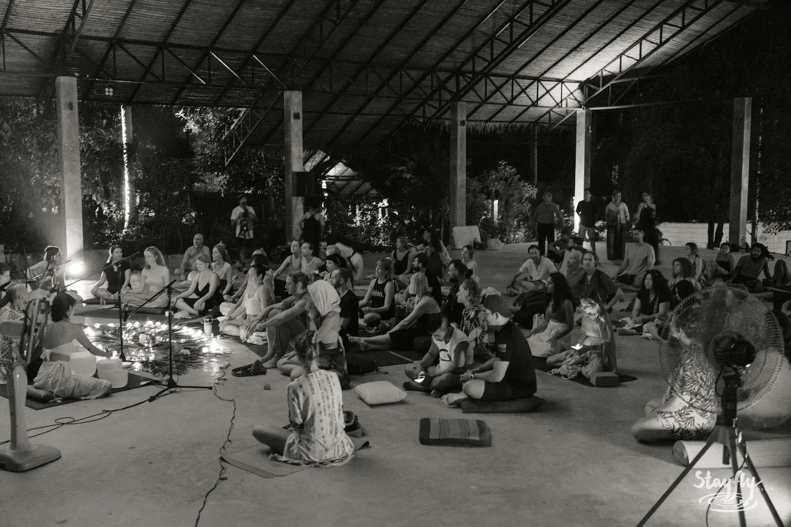 Black and white photo of seated crowd in hall.