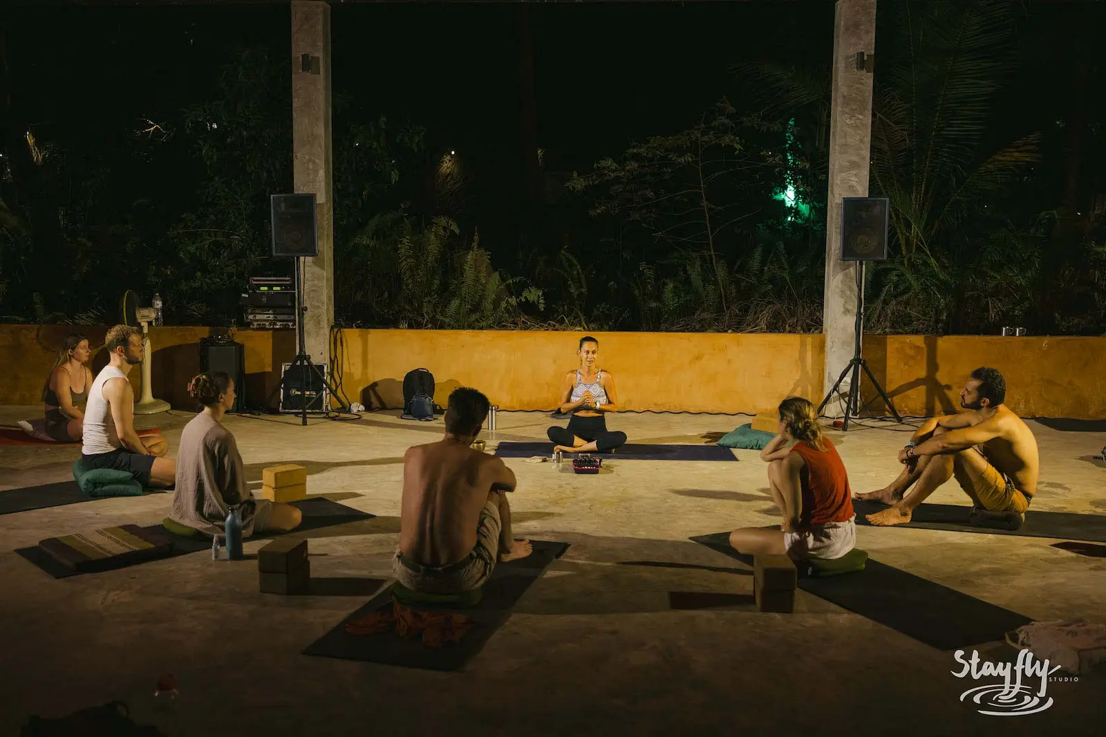 Seated circle in meditation at night.