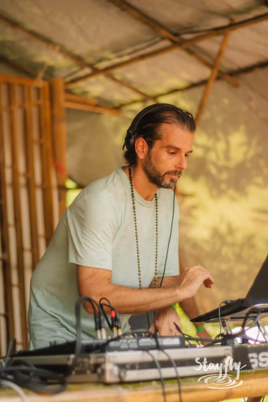 DJ with headphones at mixing deck.