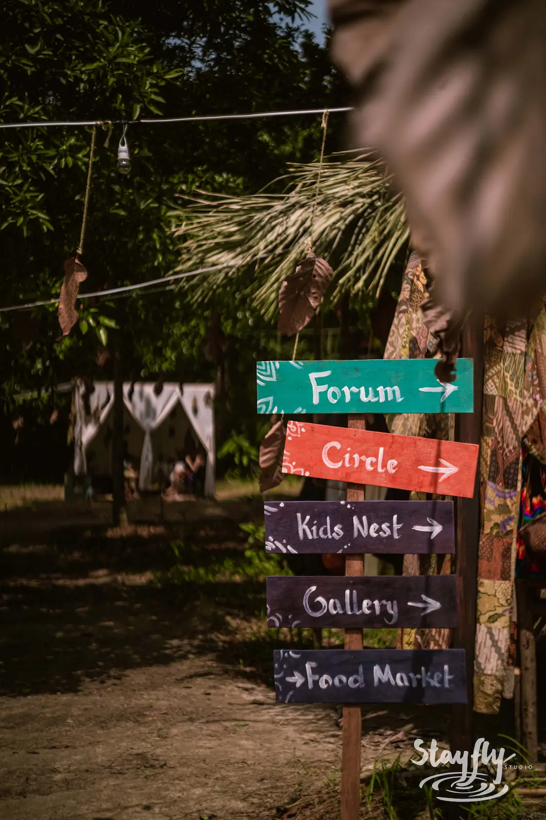Wooden wayfinding signpost with directional arrows.
