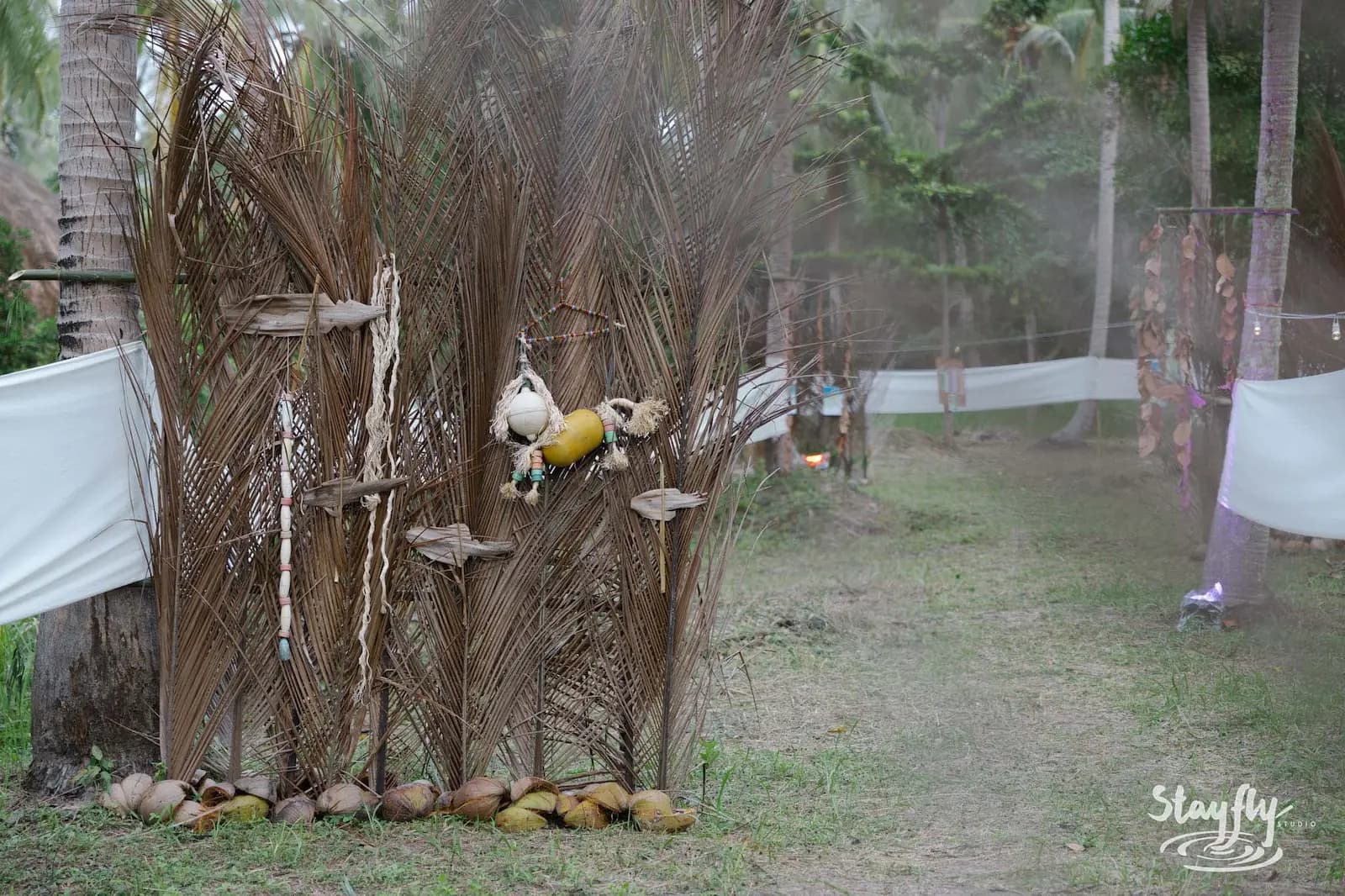 Dried palm frond altar-like installation with coconuts.