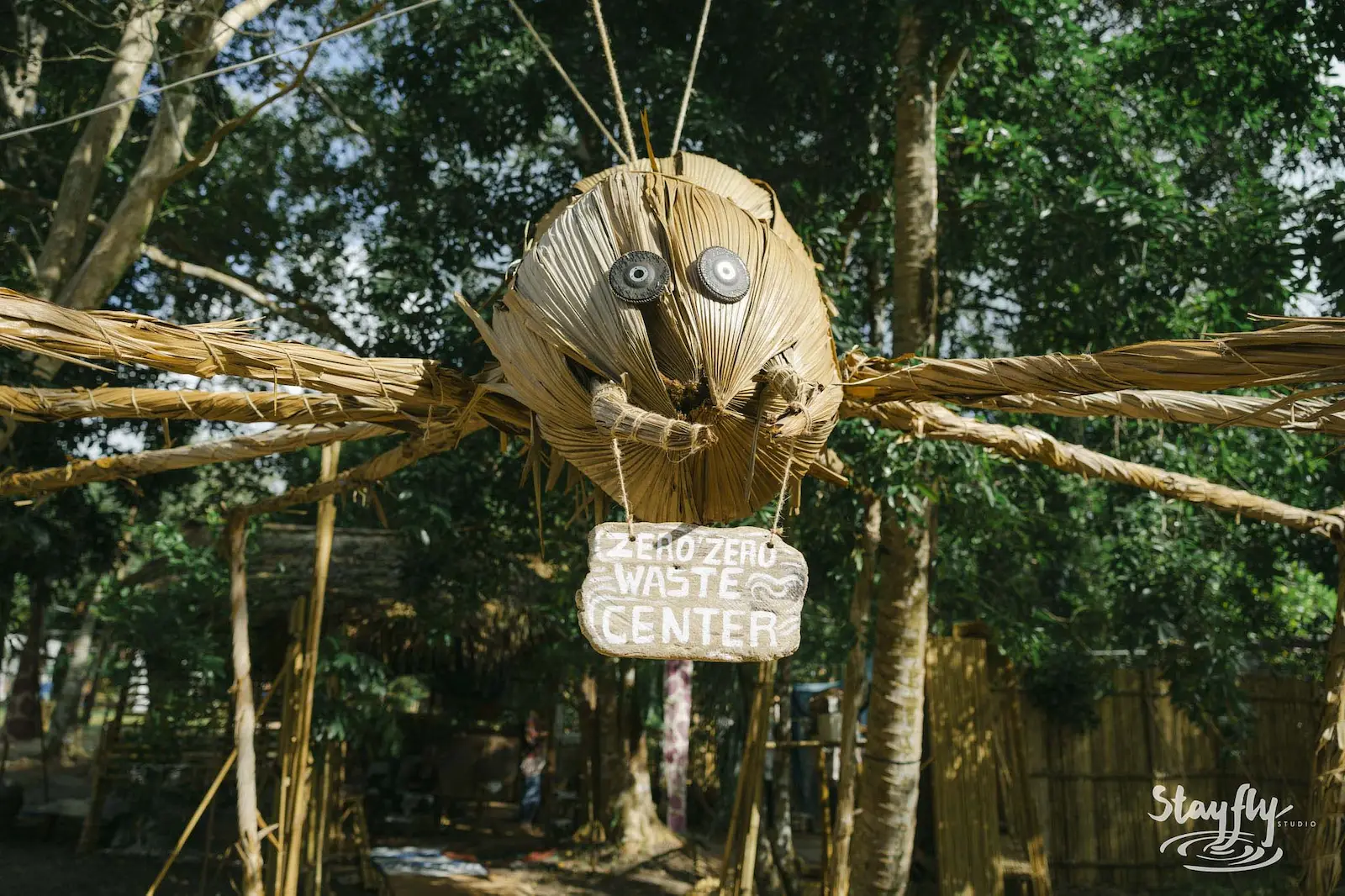 Woven bug sculpture over zero waste center sign.