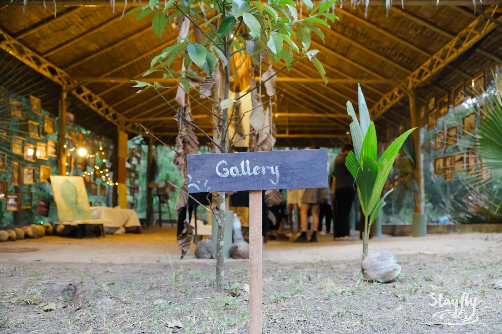 Wooden Gallery sign at bamboo pavilion entrance.