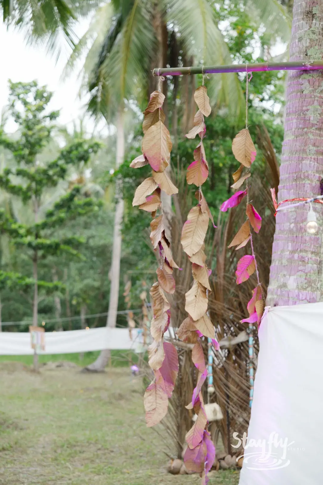 Hanging leaf decoration strung on tree.