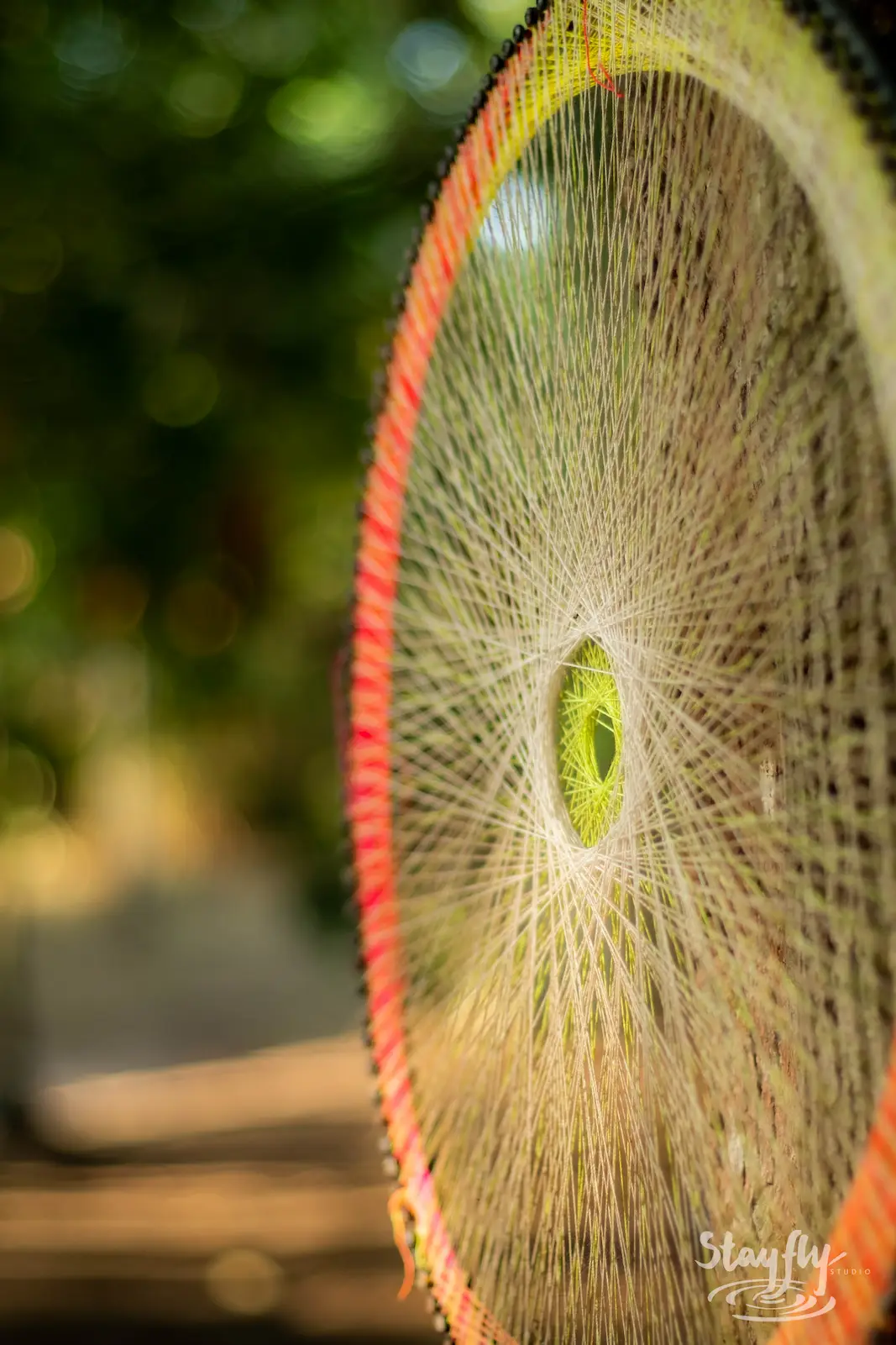 Backlit woven wheel decoration close up.