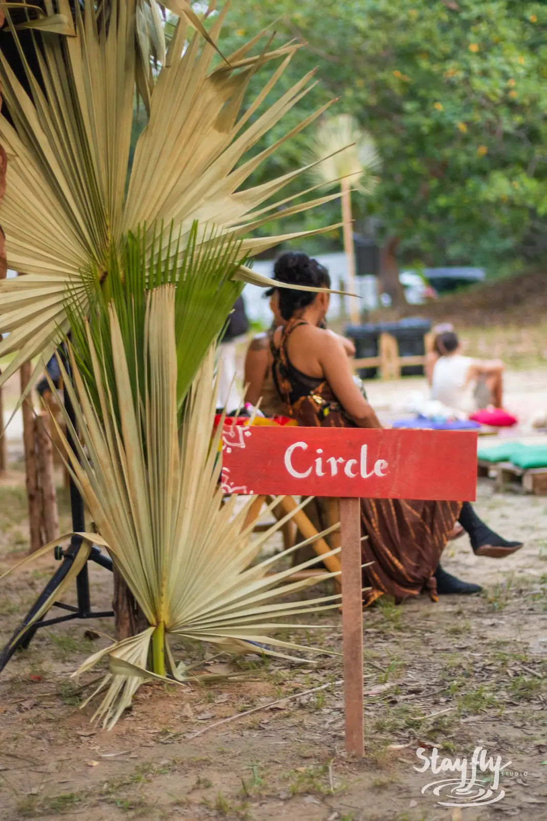 Circle wayfinding sign near seated attendees.