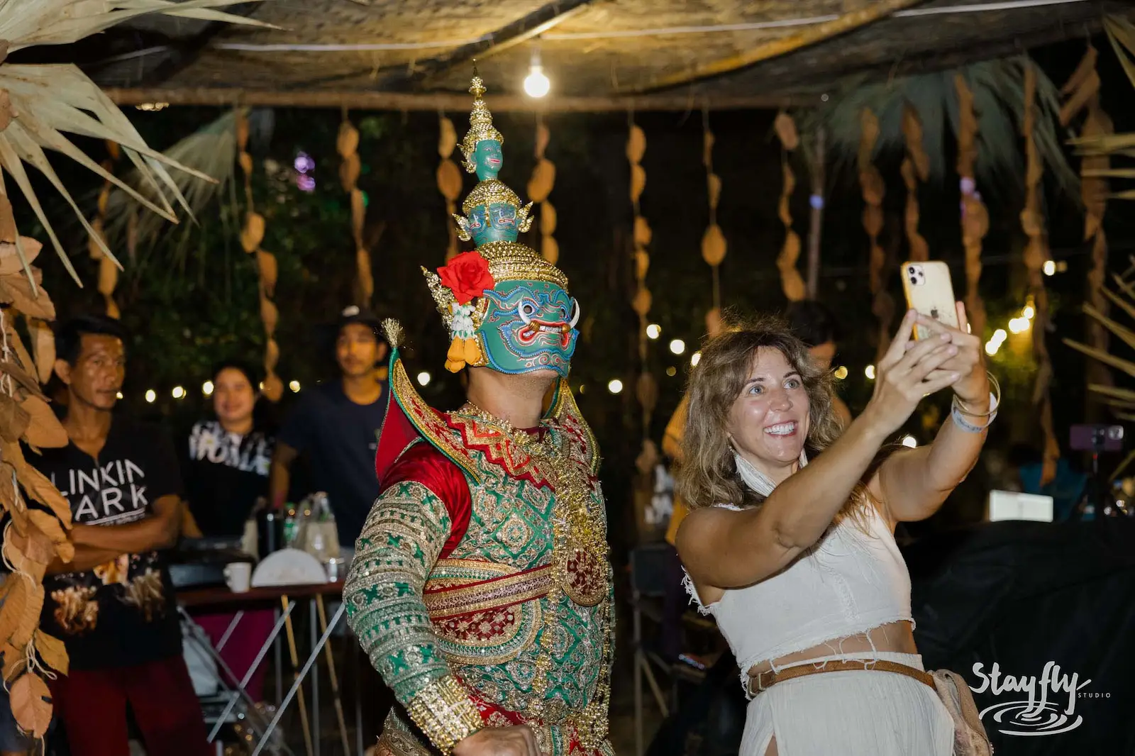 Guest selfies with masked Thai khon dancer.