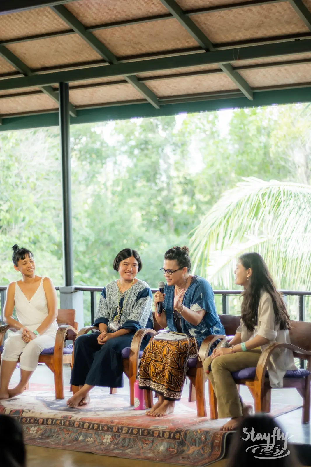 Panel discussion with four seated speakers.