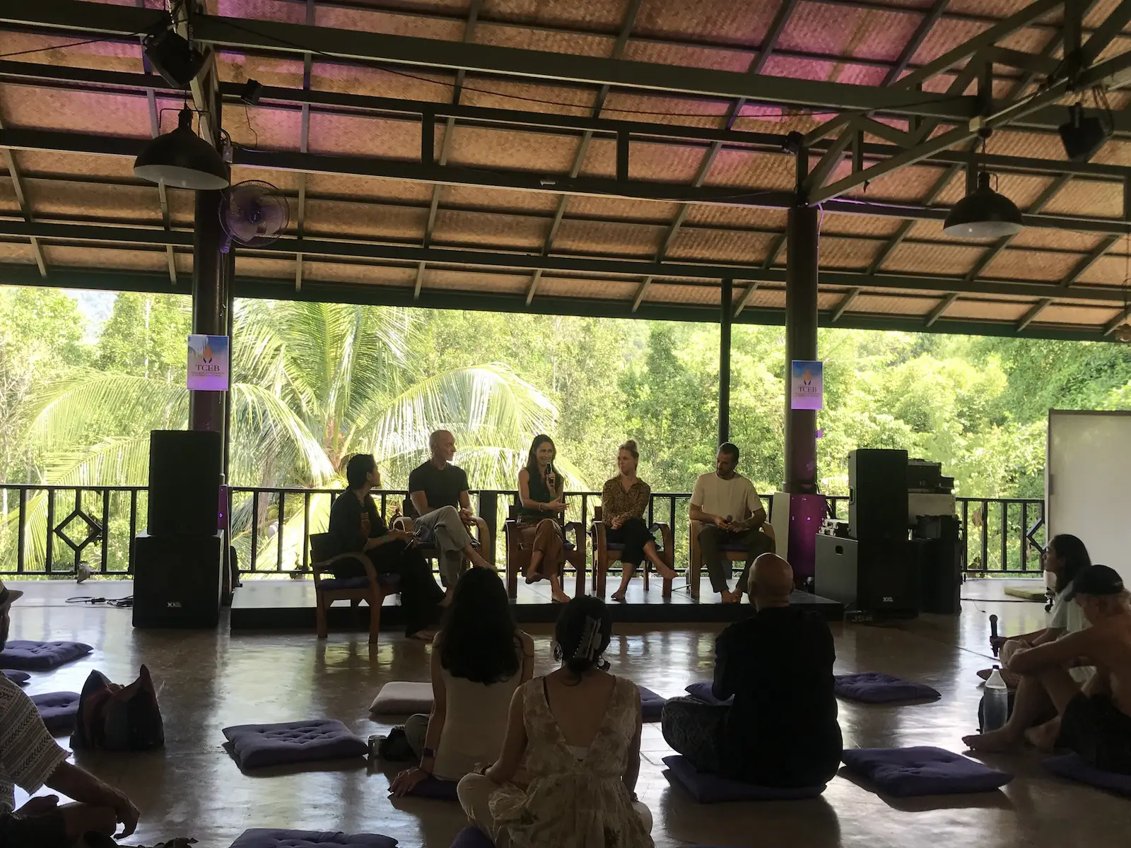 Small forum circle with seated audience outdoors.
