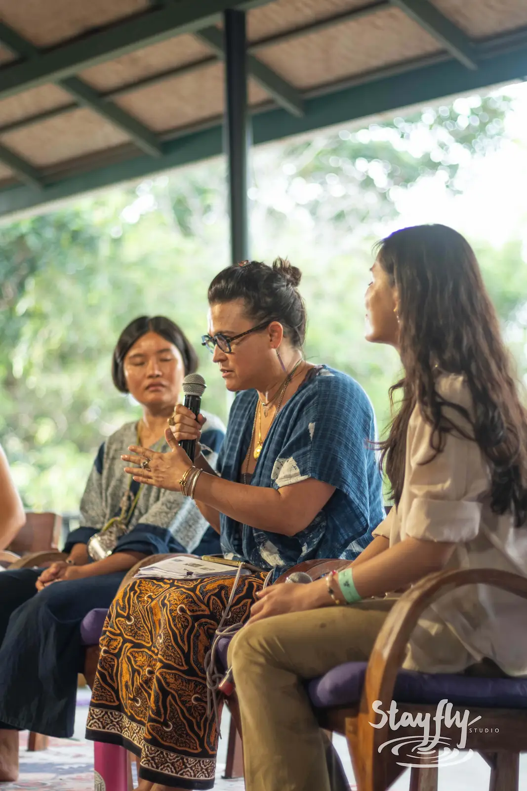Three women speaking on a forum panel.