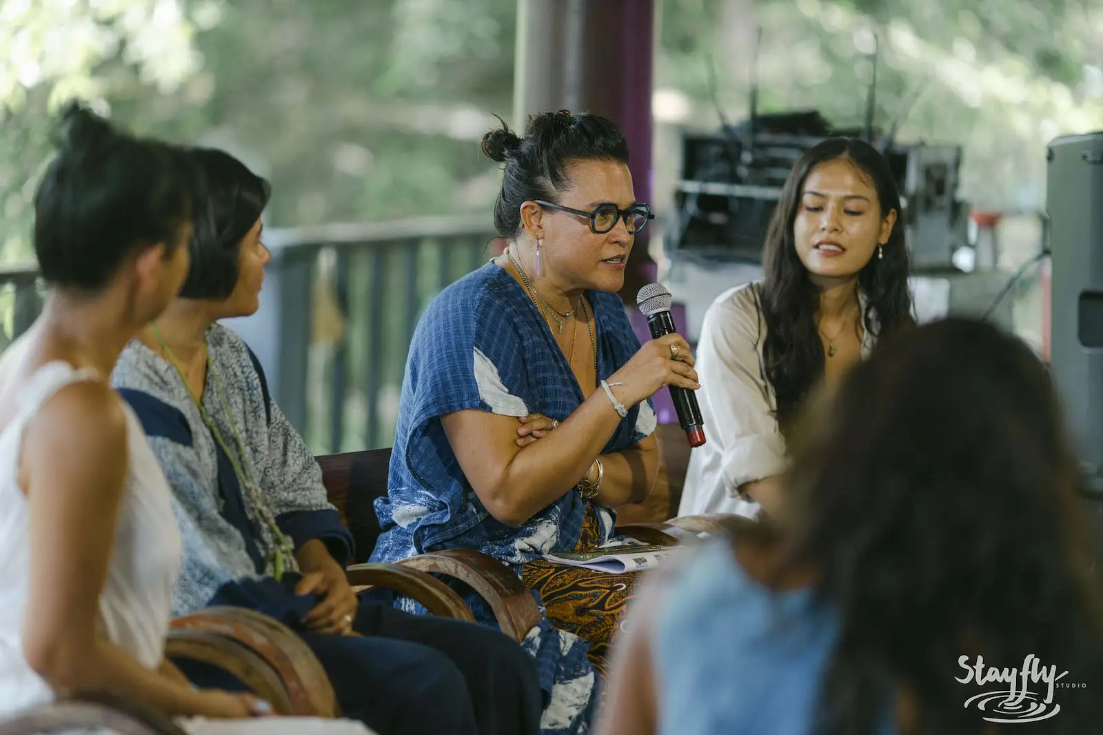 Panel discussion with woman speaking into mic.