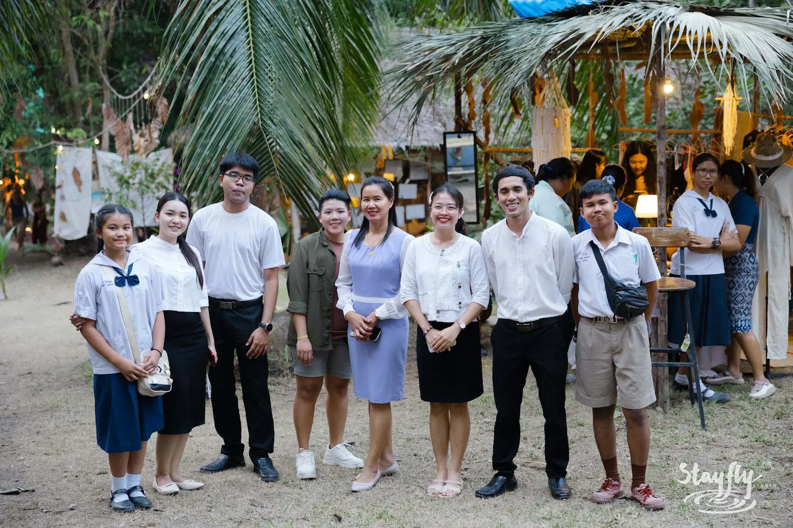 Students in school uniform posed together at dusk.