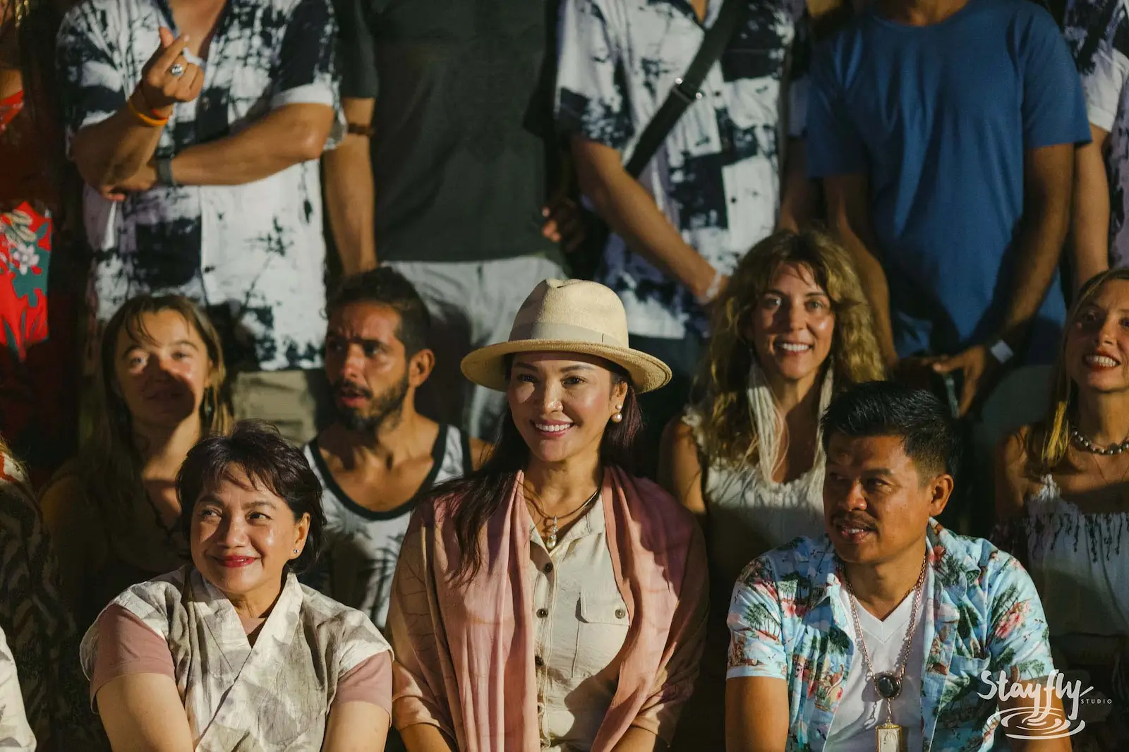 Audience seated together smiling toward camera.