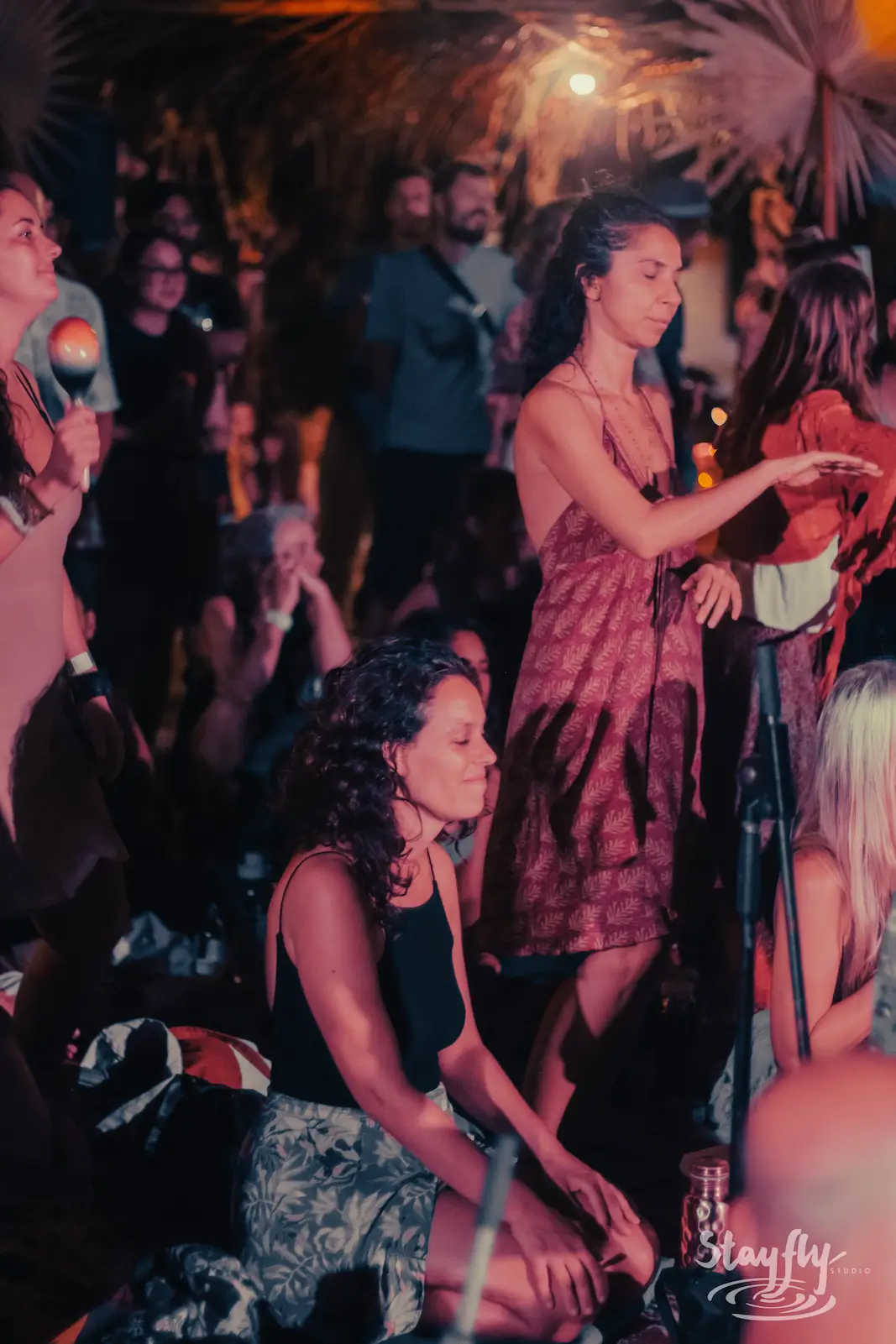 Seated crowd at night gathering.