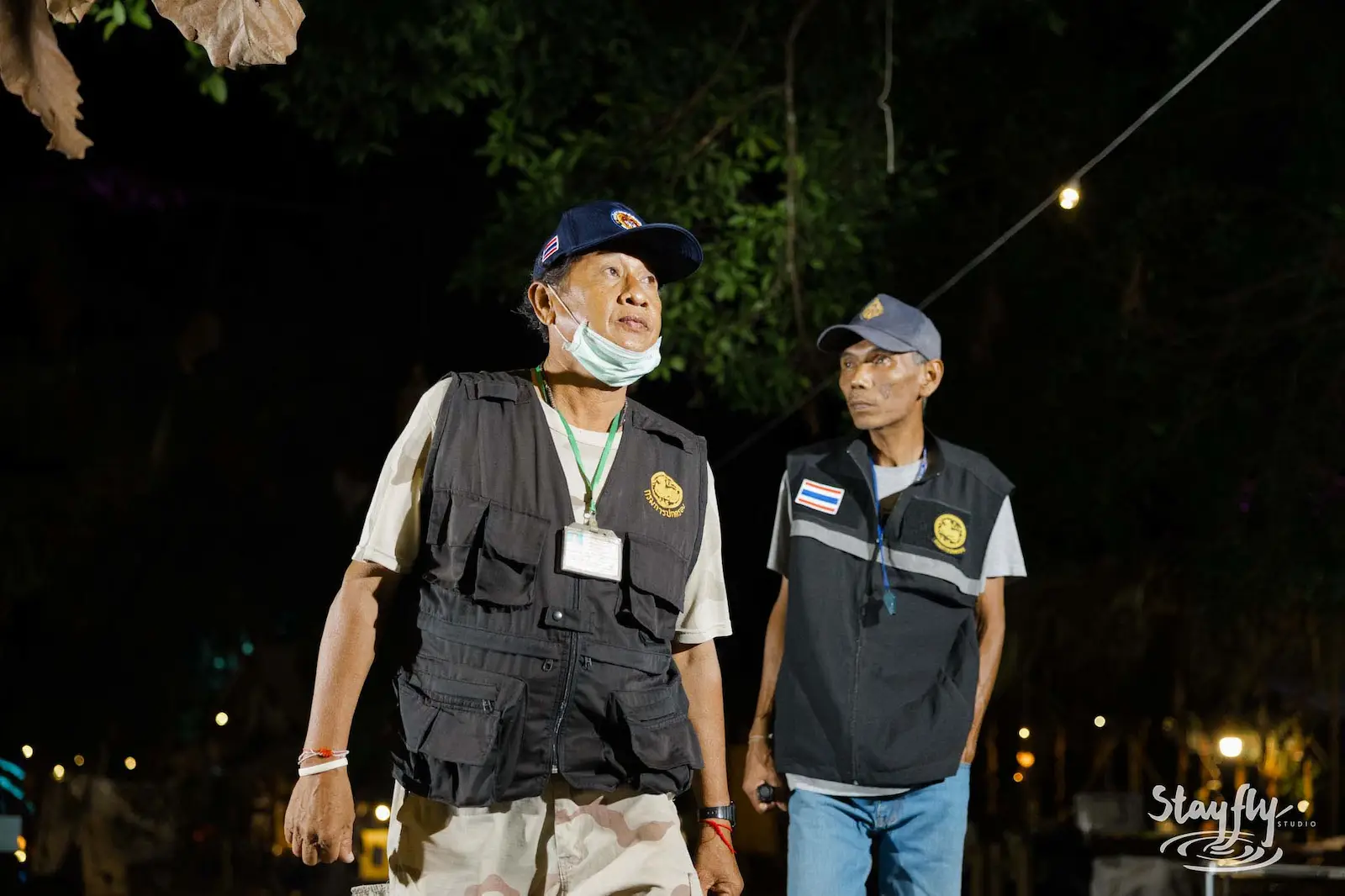 Two staff men walking at night.