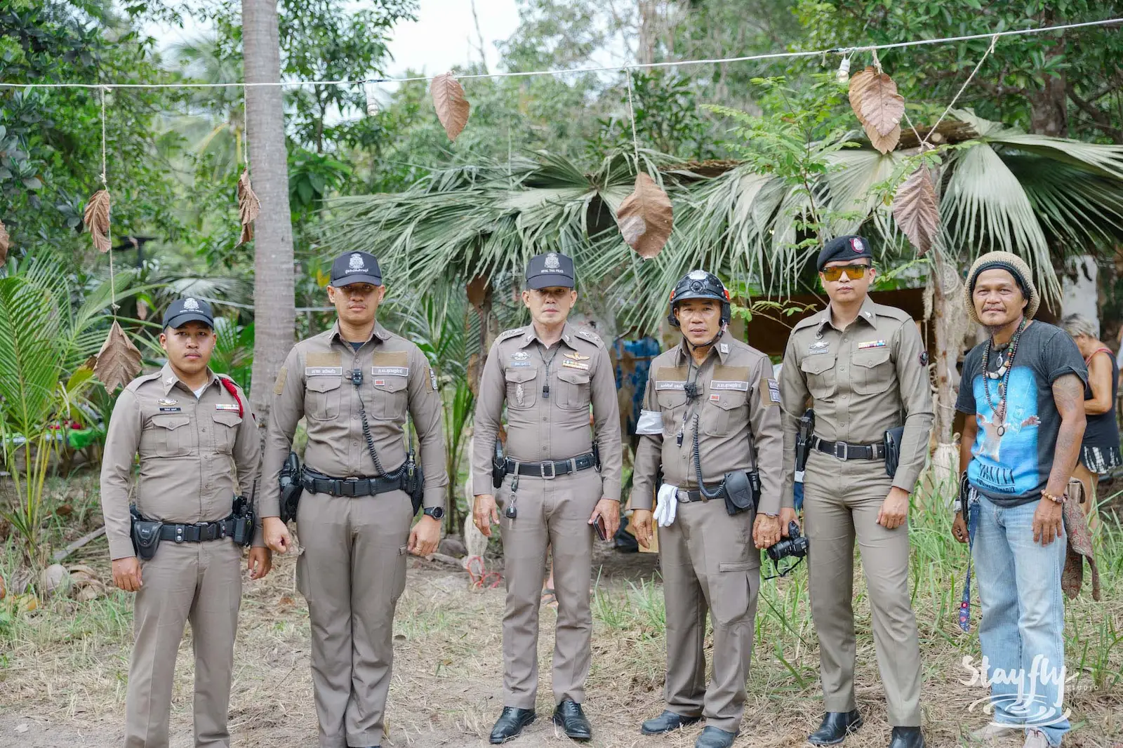 Thai police officers posing with festival staff member.