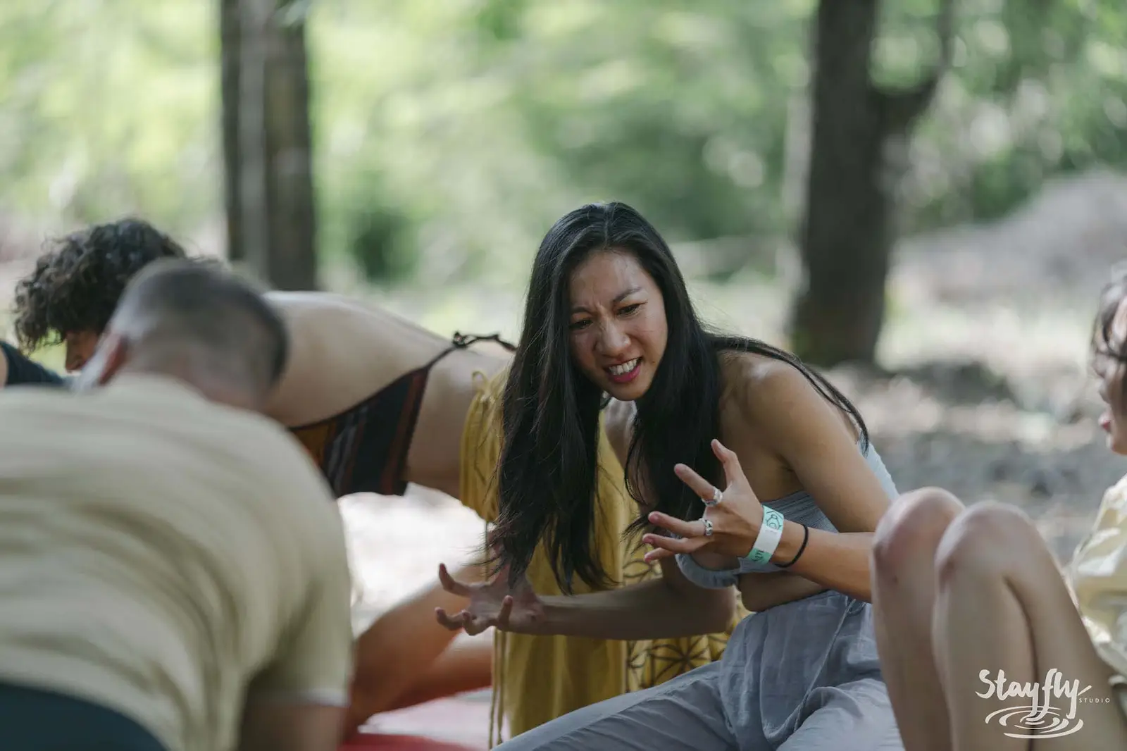 Group of people interacting playfully outdoors.