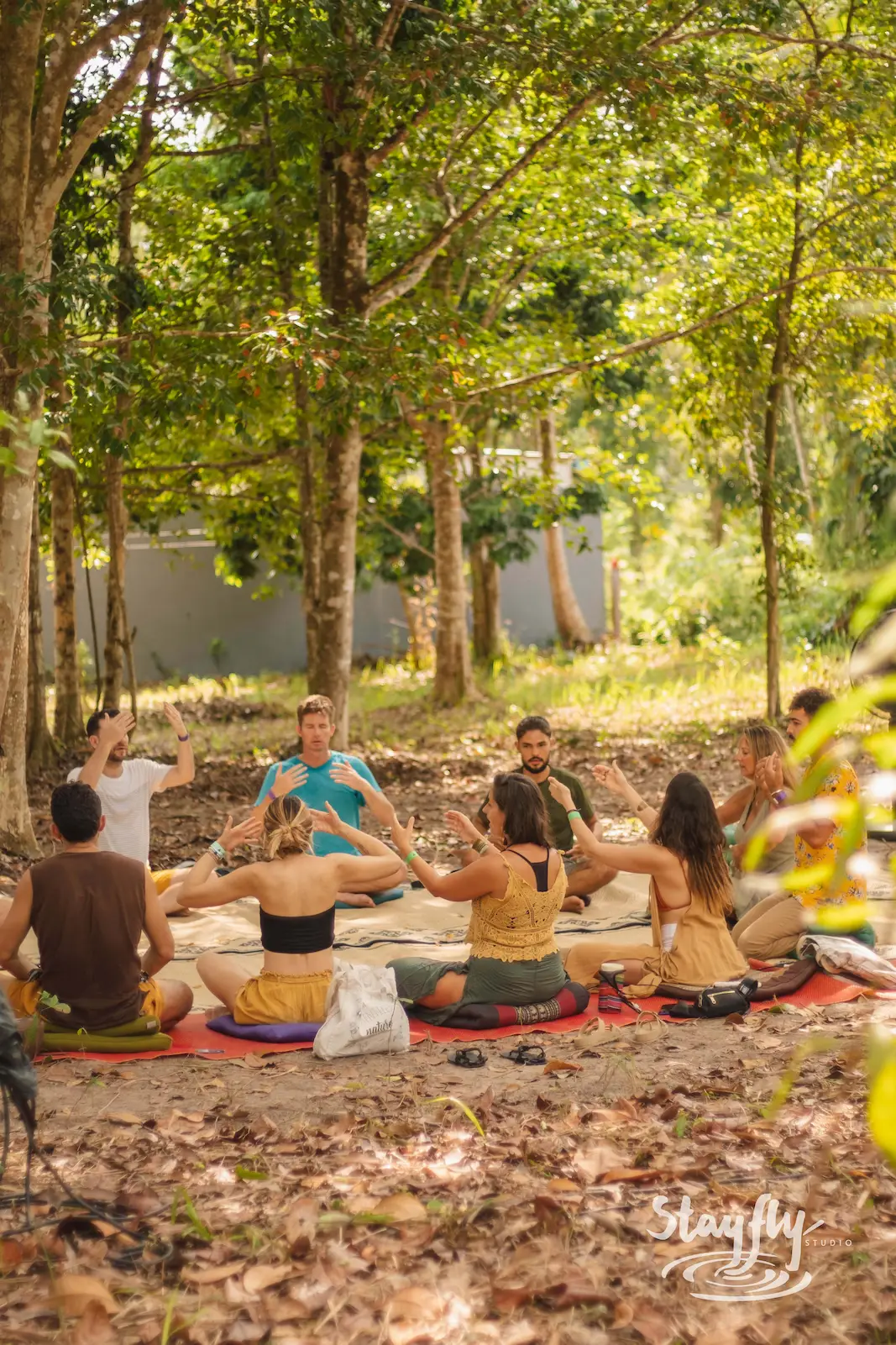 Group workshop circle seated in forest.