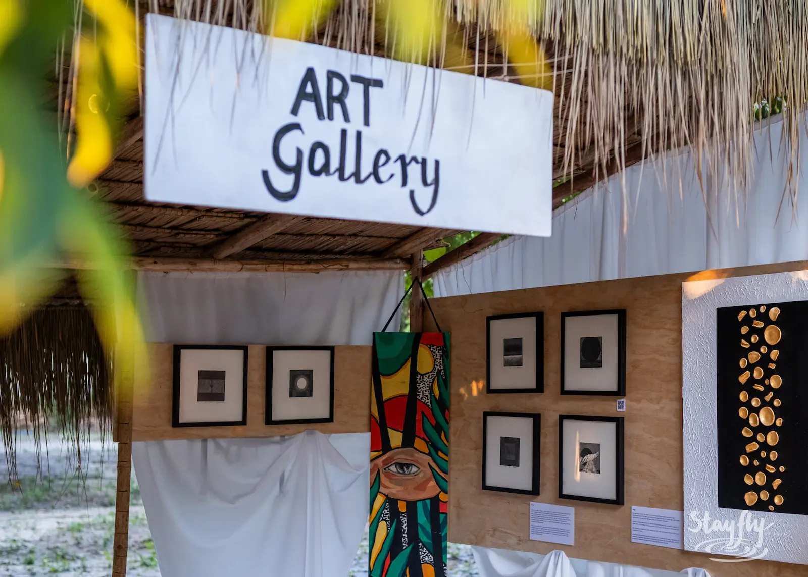 Art Gallery sign displays framed artworks.