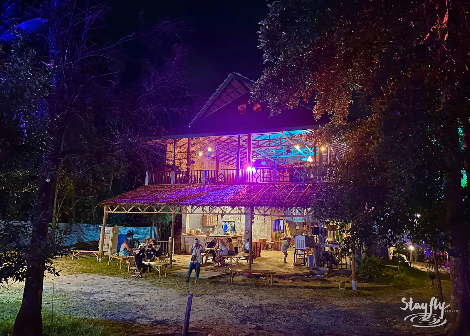 Two-story venue building lit at night.